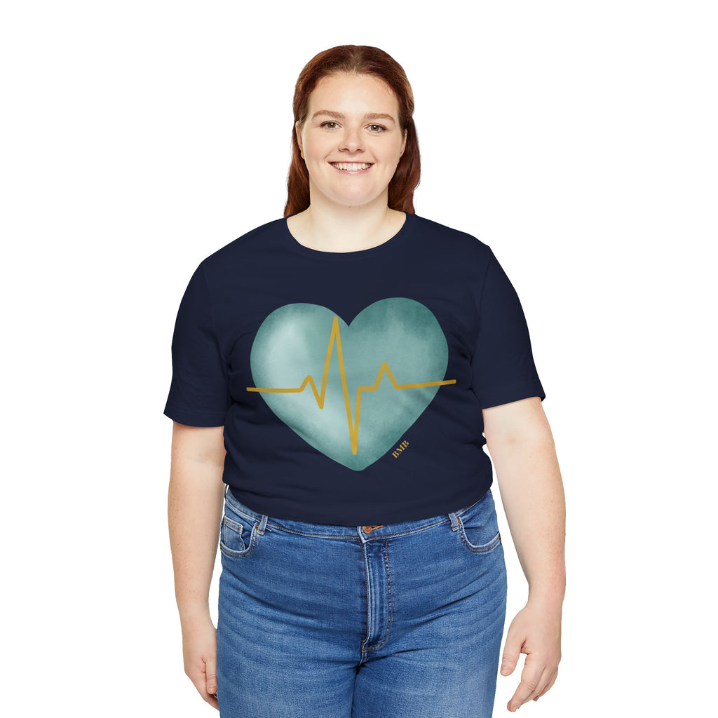 Woman wearing navy Heartbeat Heart Tee with teal watercolor heart — Nurses Week 2026 gift