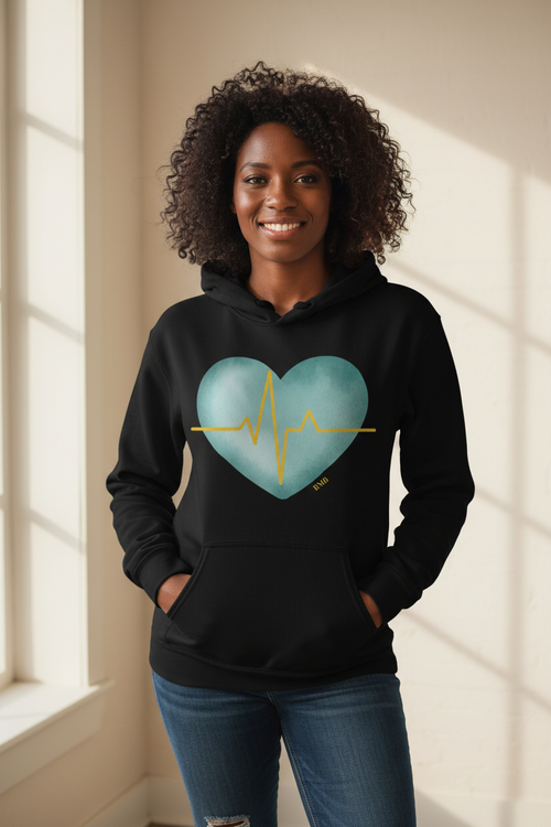 Black woman wearing black Heartbeat Heart Hoodie with teal watercolor heart and gold EKG line — Nurses Week gift