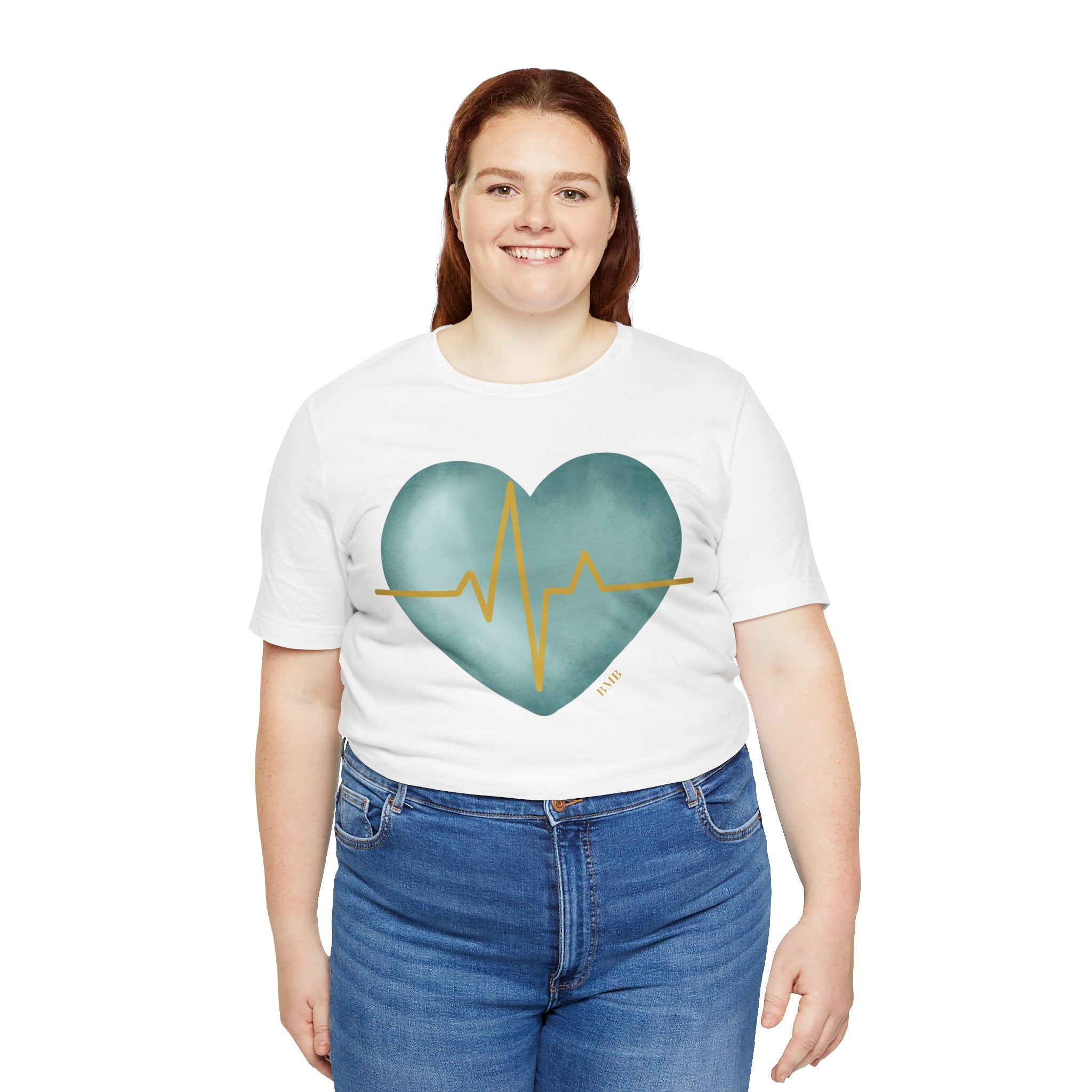 Woman wearing white Heartbeat Heart Tee with teal watercolor heart — Nurses Week 2026 gift