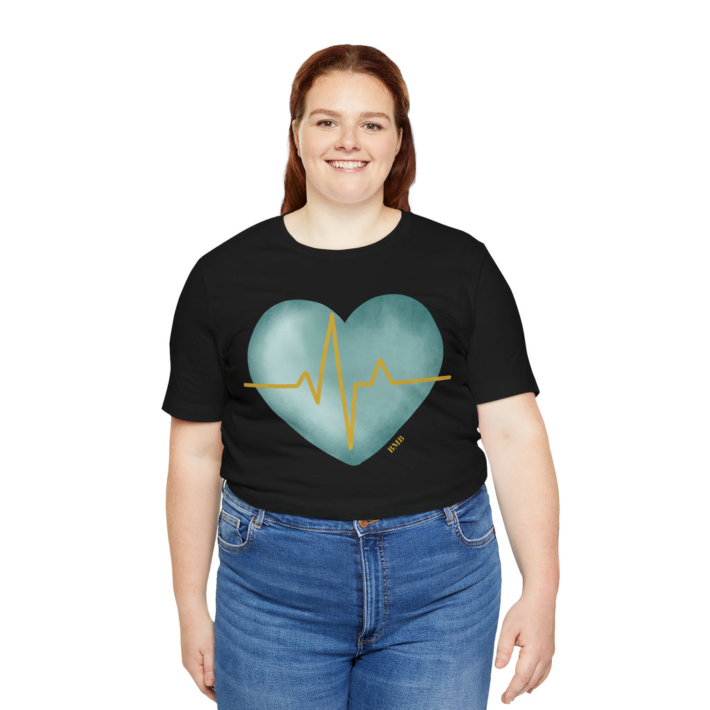 Woman wearing black Heartbeat Heart Tee with teal watercolor heart — Nurses Week 2026 gift