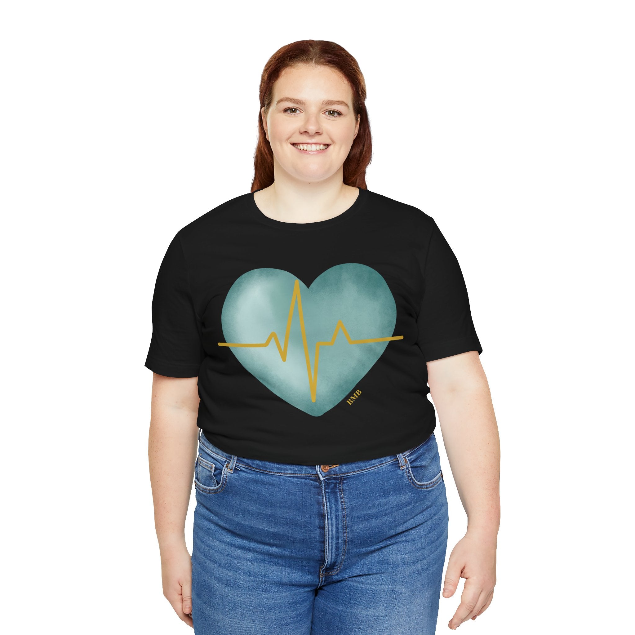 Woman wearing black Heartbeat Heart Tee with teal watercolor heart — Nurses Week 2026 gift